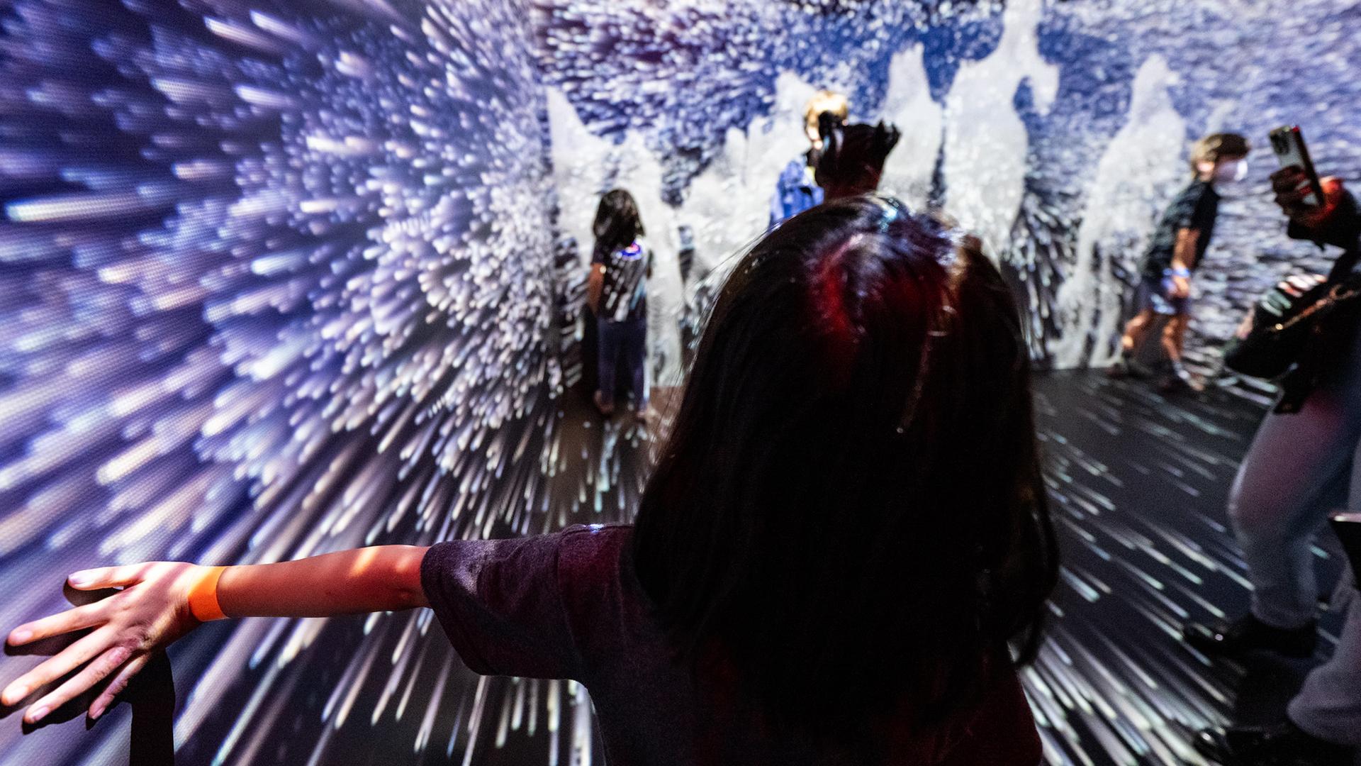 STEM event participants experiencing the immersive display at NASA Headquarters.